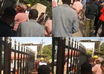 Angry Abuja Residents Forcefully Unlock Gate Of A Bank As Naira Scarcity Persists (Video)